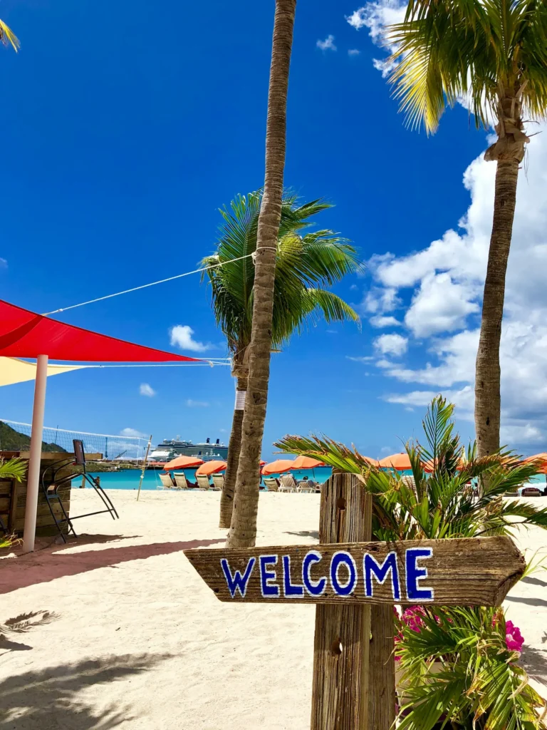Welcome sign and beach view at a popular stop on St Maarten boat tours