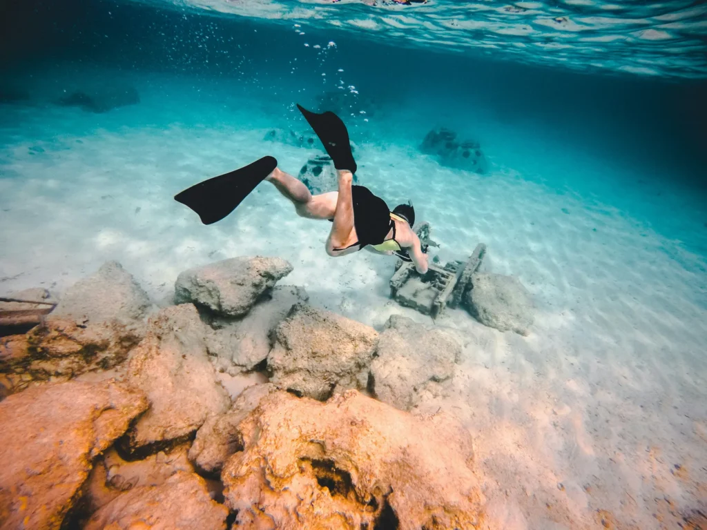 Snorkeler exploring coral reef during St Martin boat tours