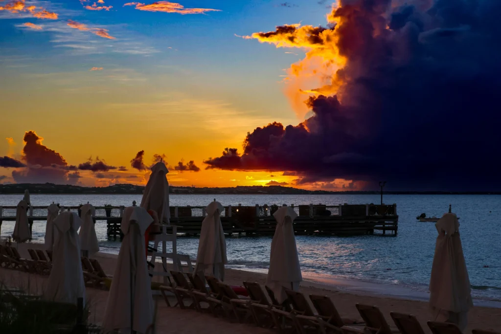 Cloud-draped sky and glowing sunset views from the coast of St Maarten on an evening cruise