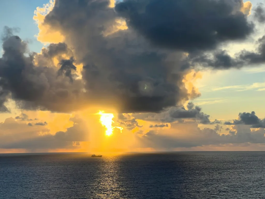Dramatic sunset lighting up the ocean horizon on a St Maarten sunset cruise