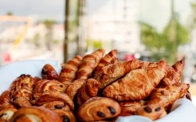 Basket filled with fresh French pastries including croissants and pain au chocolat. Things to do in St Martin
