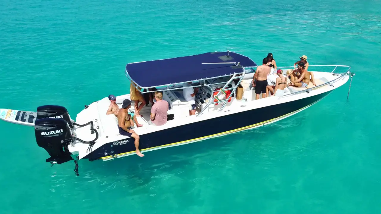 people enjoying a day on the powerboat boat in crystal clear turquoise waters