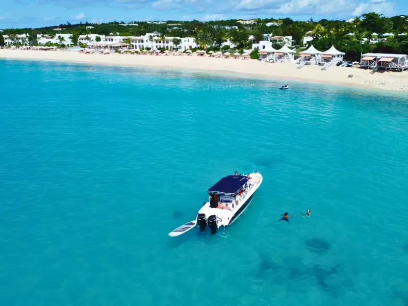 Luxury boat anchored at pristine white-sand beach in Anguilla with turquoise waters