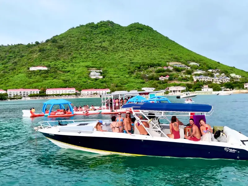 Family enjoying a boat charter with swimming and paddleboarding in turquoise water