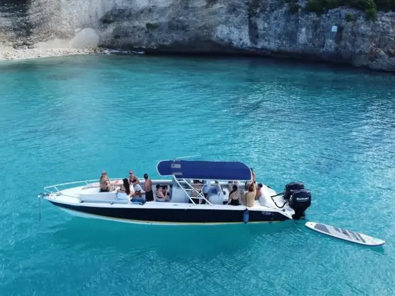Boat moored in hidden Little Bay cove, Anguilla, surrounded by cliffs