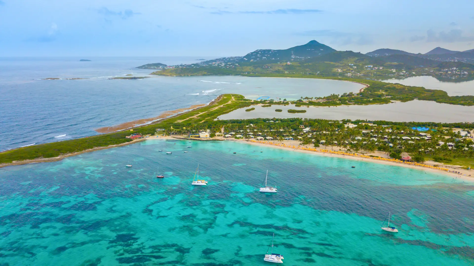 Orient Bay St Martin wide aerial with long sandy beach and waves