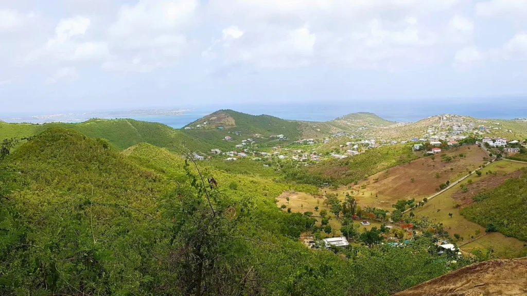 Panoramic hillside view over St Martin island with lush hills and Caribbean Sea