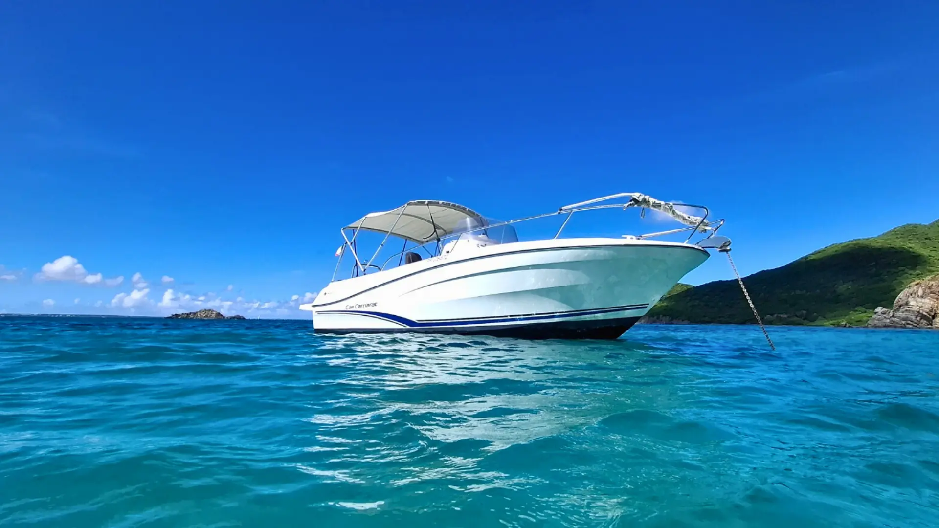 Your private boat charter Cap Camaret is anchored in turquoise water St martin