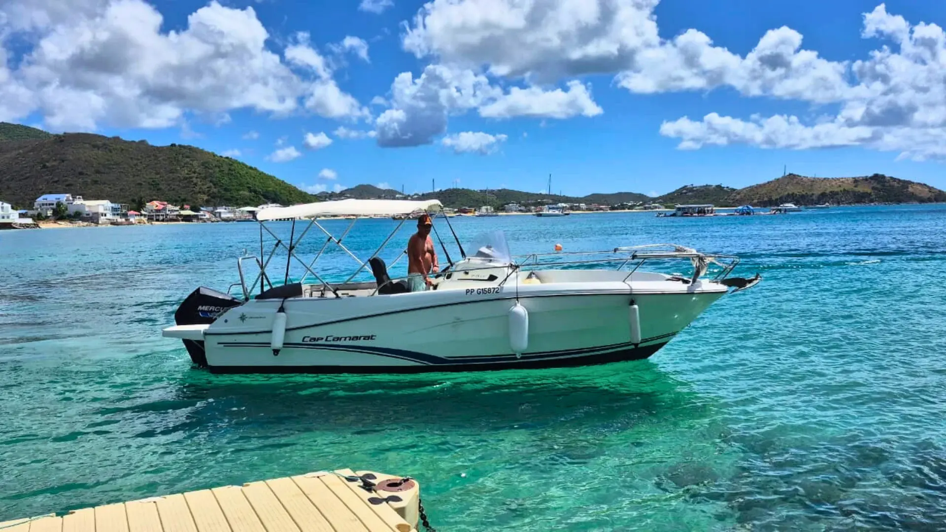 Grand Case bay, St Martin captain with motor boat on a private boat charter