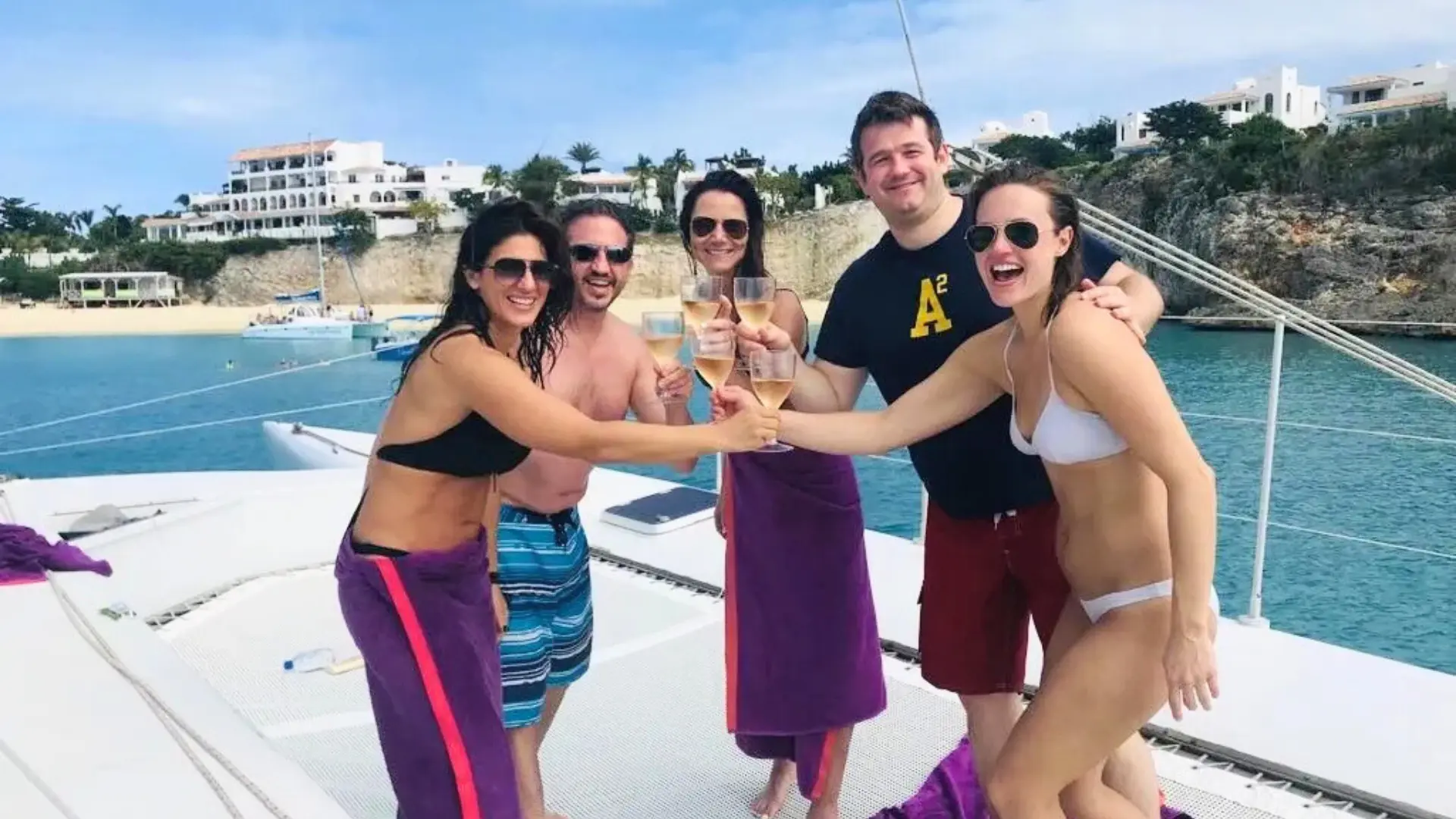 Guests cheers a glass of wine onboard private charter st maarten
