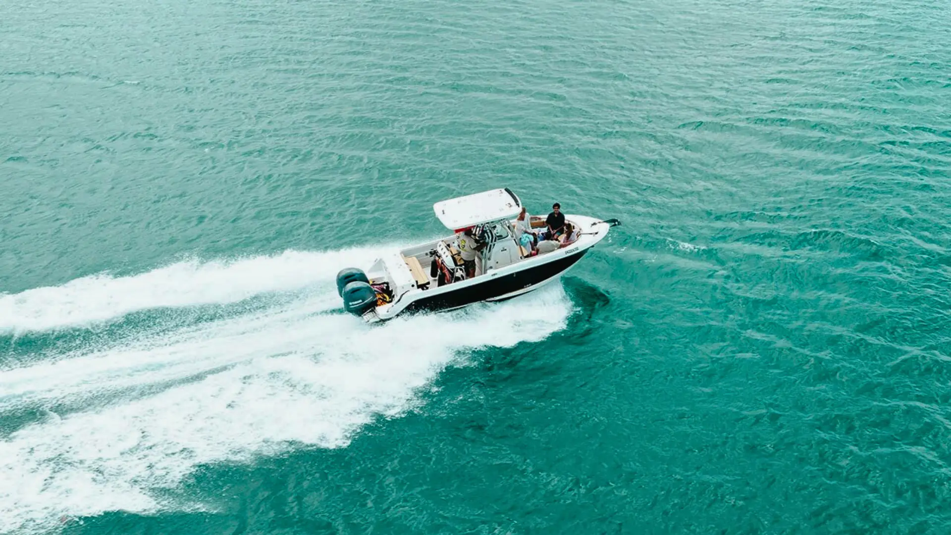 Private powerboat cruising over turquoise waters off St Martin