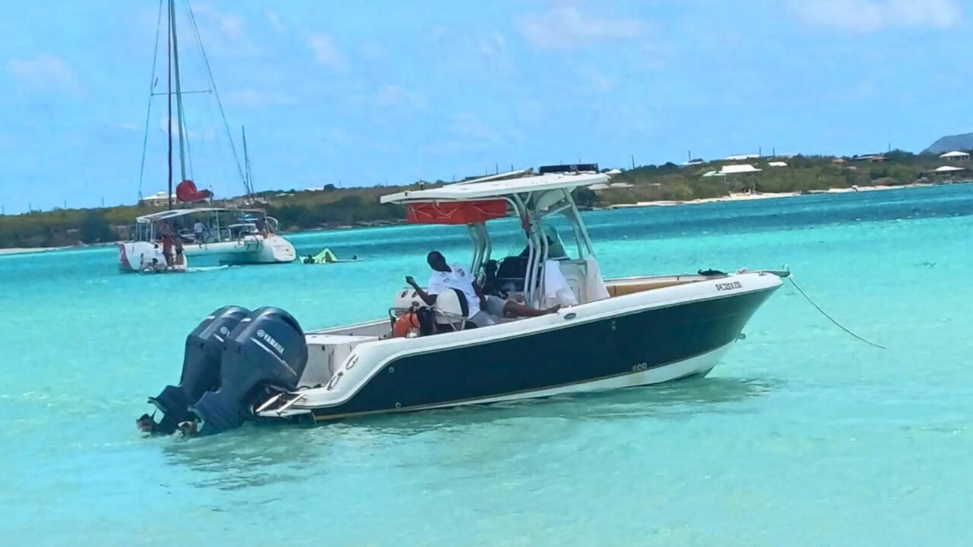 Private motorboat anchored near Anguilla with turquoise blue backdrop
