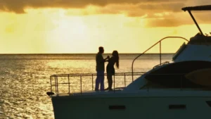 Romantic couple enjoying a sunset on the bow of a private catamaran in St Maarten
