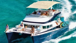Luxury motor catamaran sailing through turquoise Caribbean water near St Martin