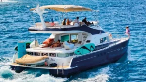 Private yacht cruising in St Martin with guests lounging on the aft deck and water toys on board