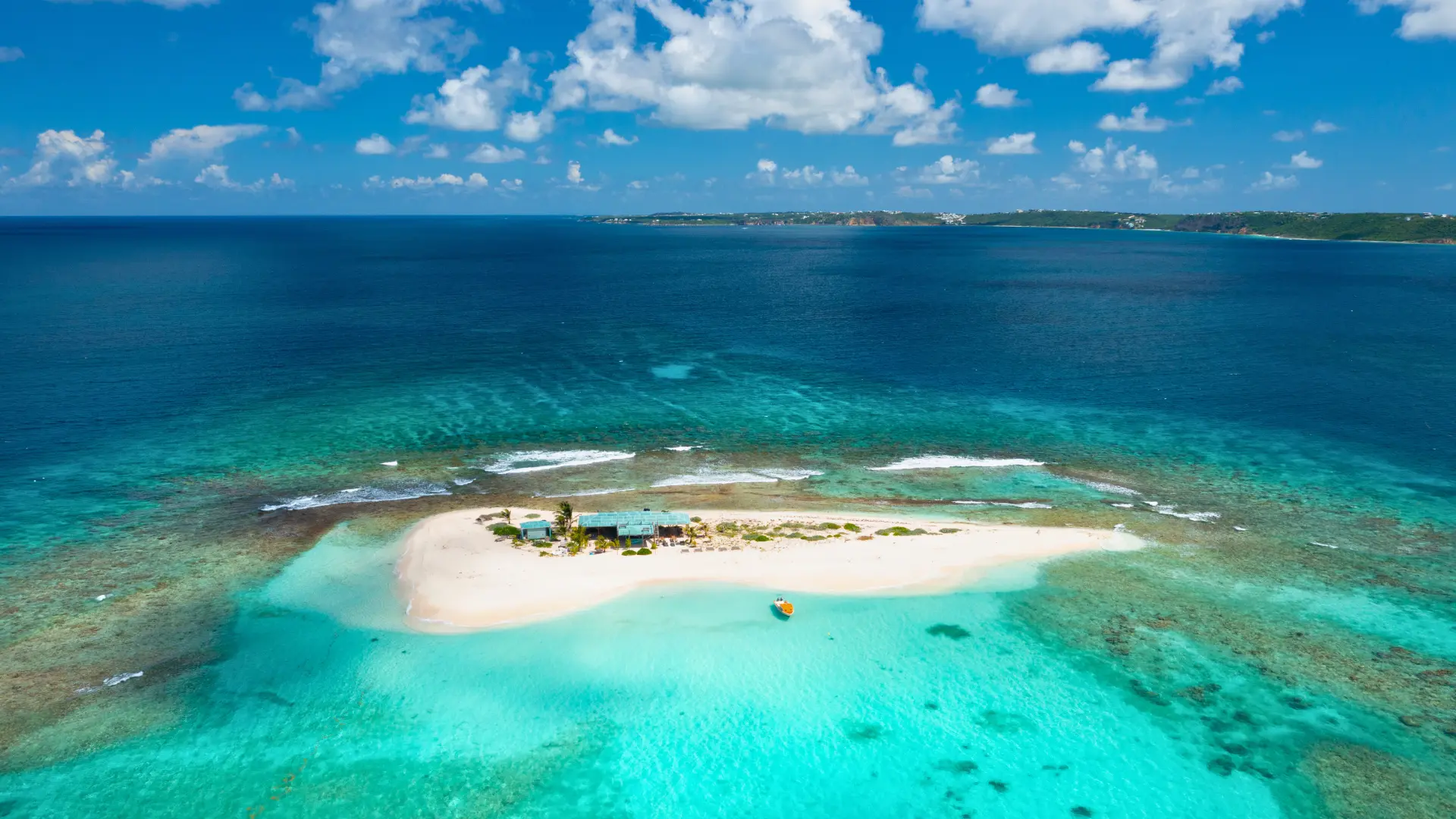 Sandy Island aerial hot with Anguilla on horizon