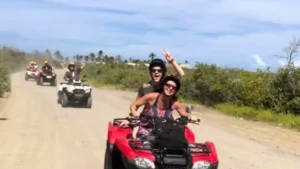 Couple riding double ATV on off-road island adventure in St Maarten