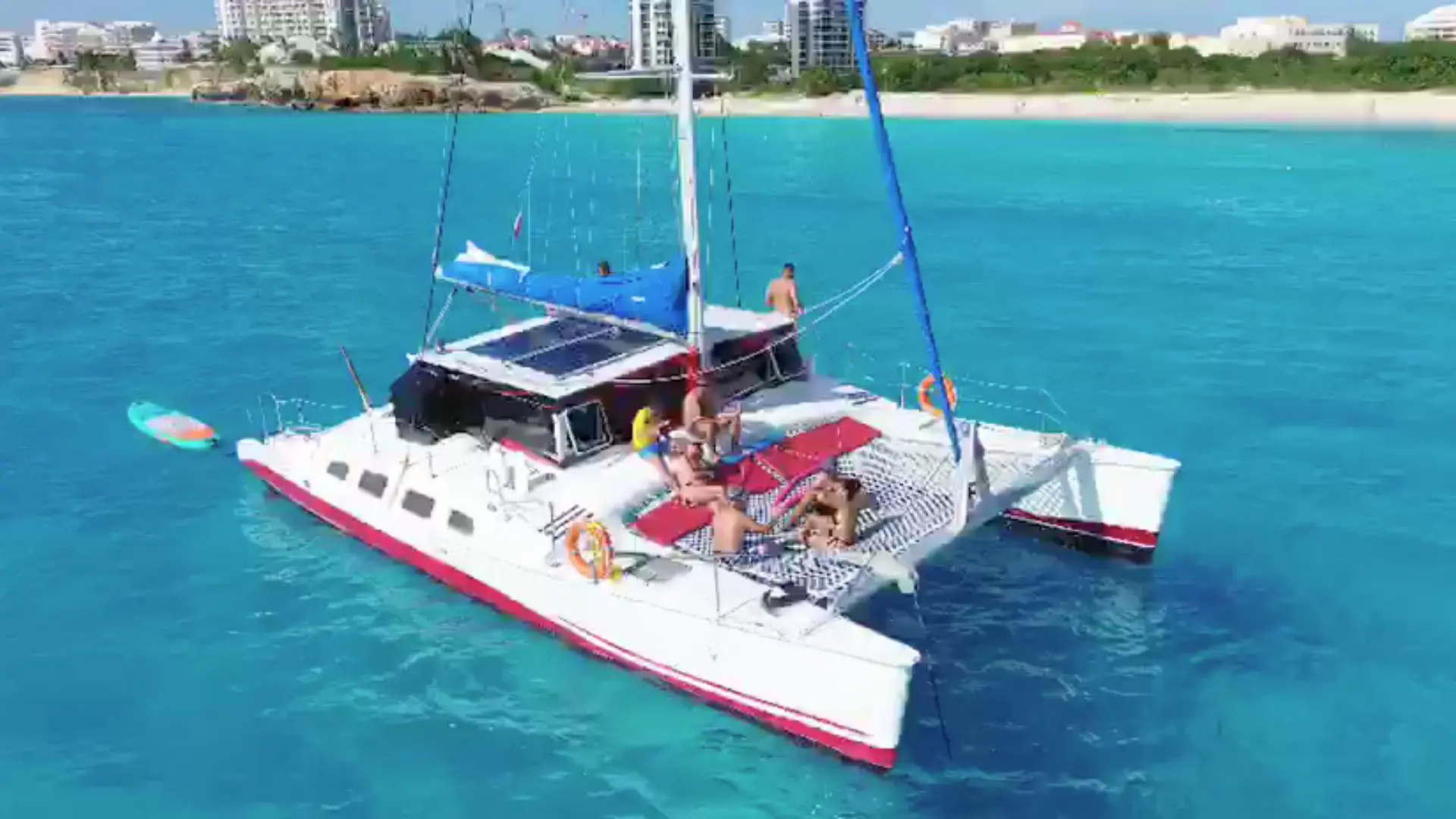 Catamaran sailing off the coast of Sint Maarten surrounded by crystal-clear blue water