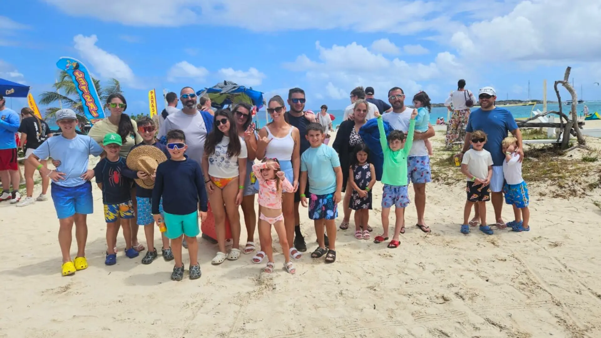 Large family group enjoying a beach stop during a full-day island tour in St Maarten
