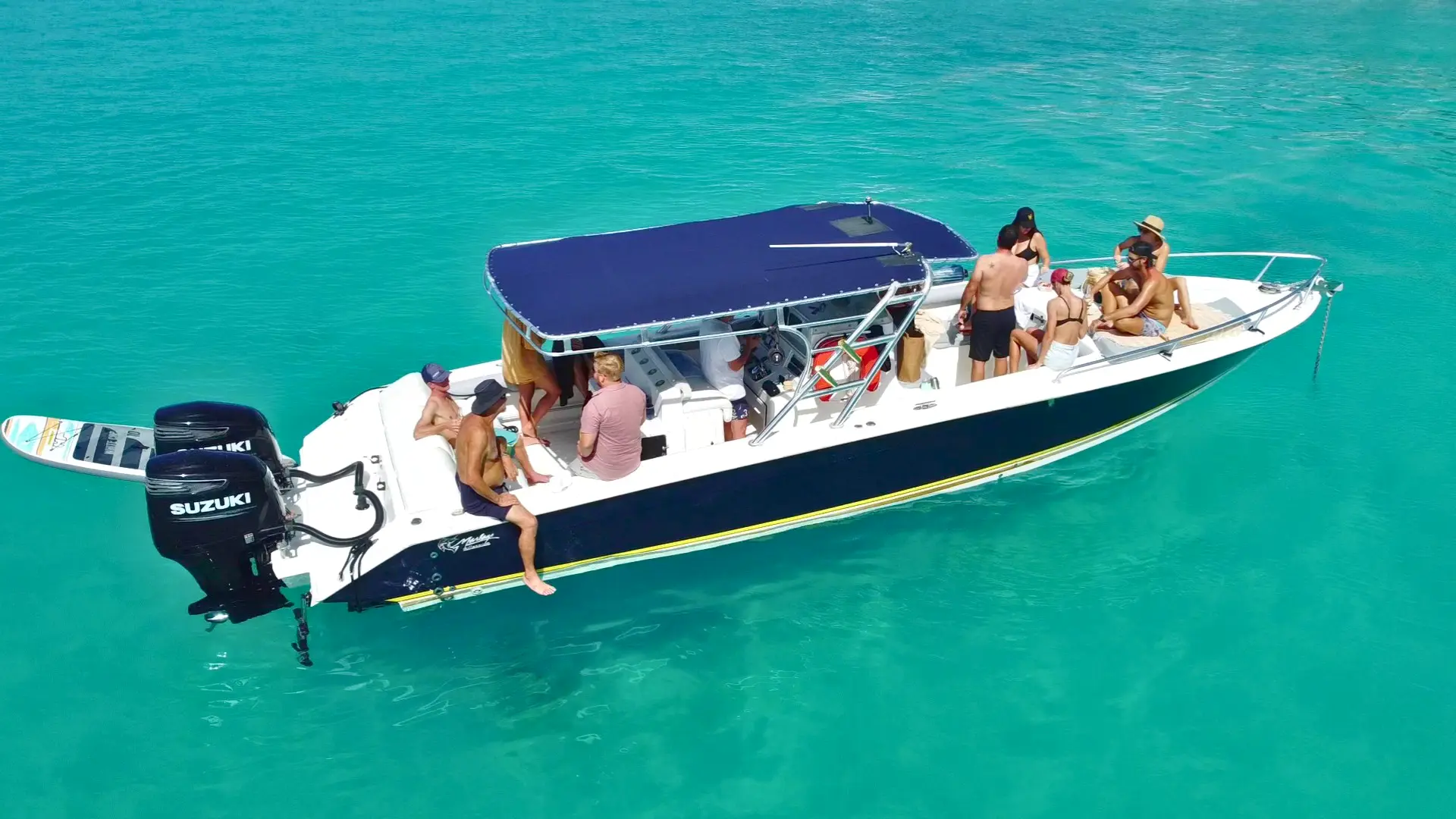 private boat charter with guests anchored in turquoise water of mullet bay st maarten