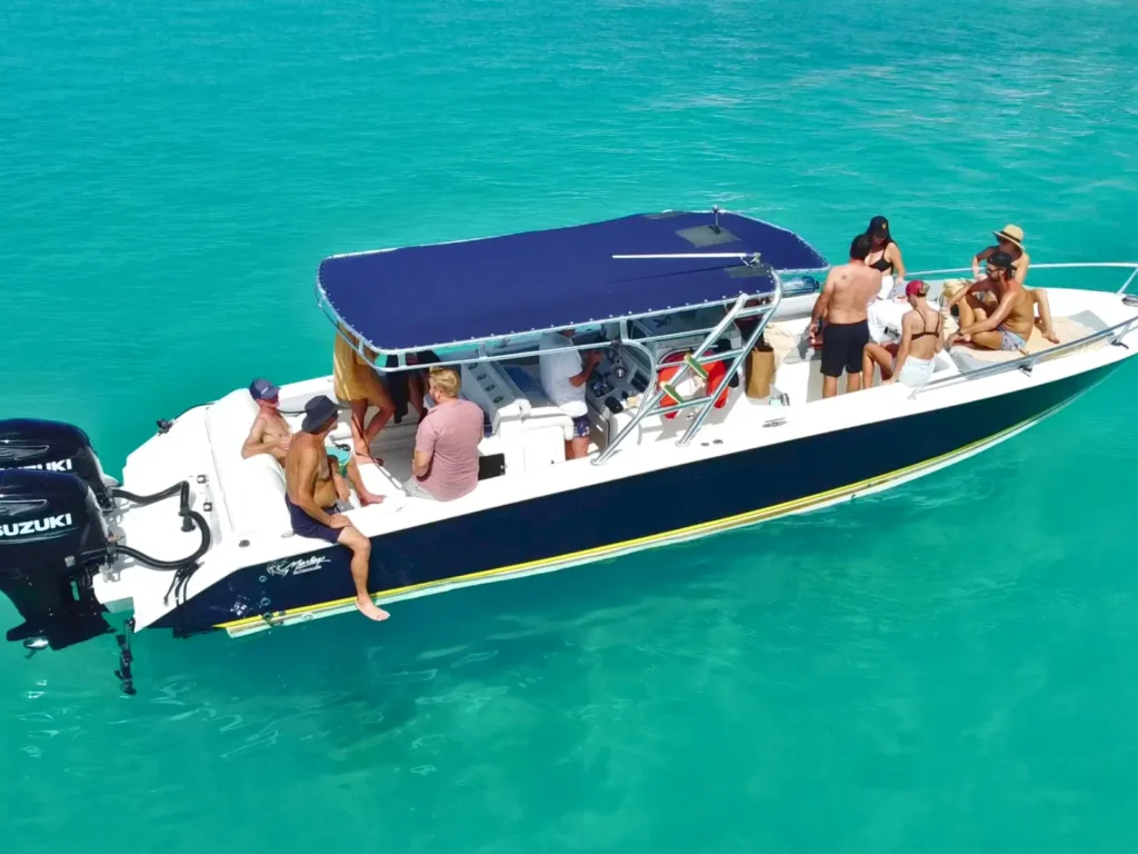 35-foot Malargo private boat charter anchored in St Barts with guests swimming in clear blue water