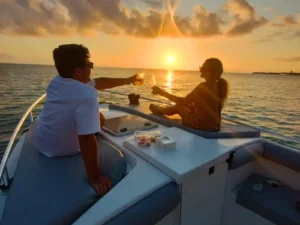 Couple enjoying a romantic sunset private boat charter in St Martin with champagne on board