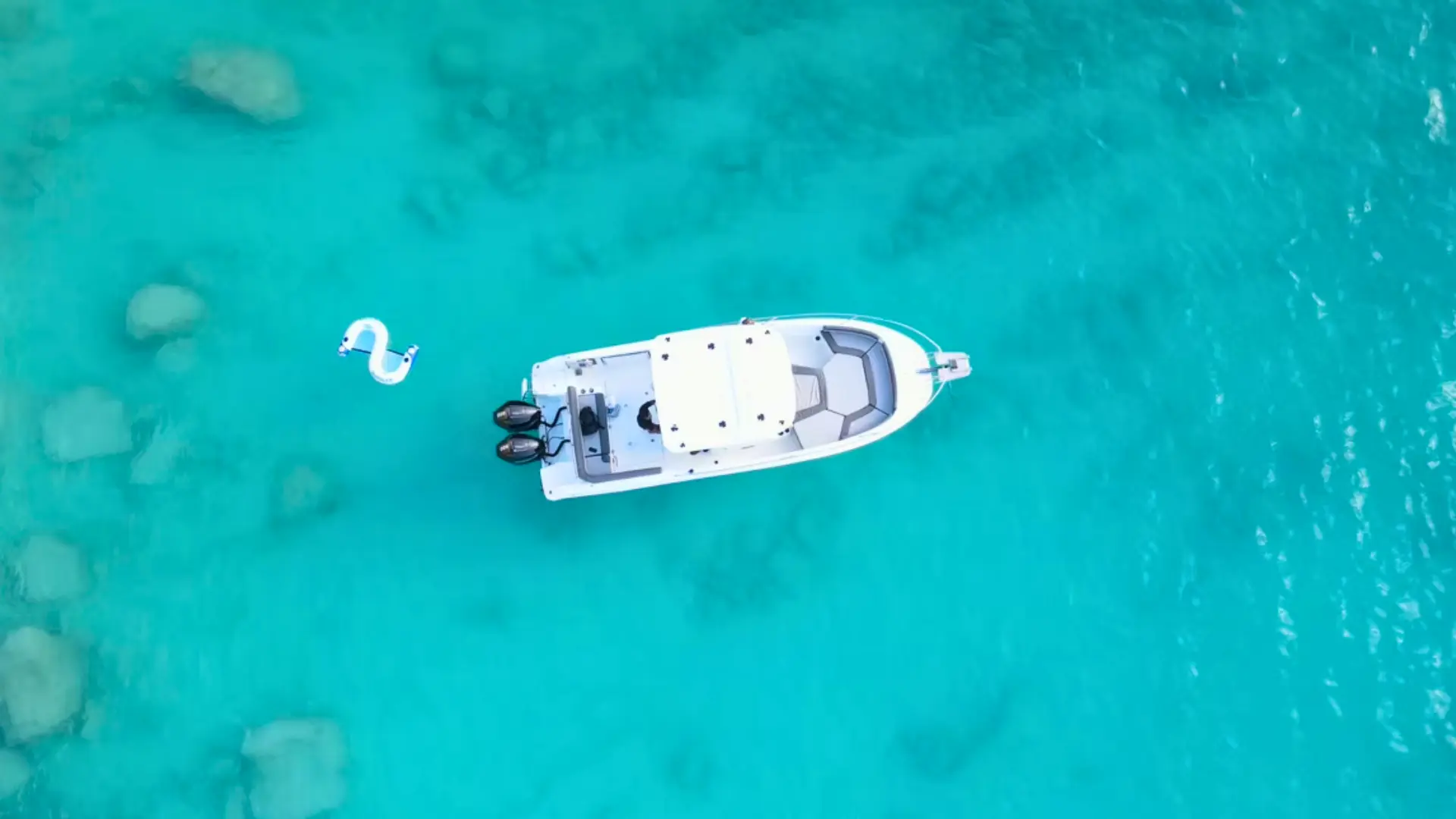 Two women relaxing on a private speedboat at sunset off St Martin