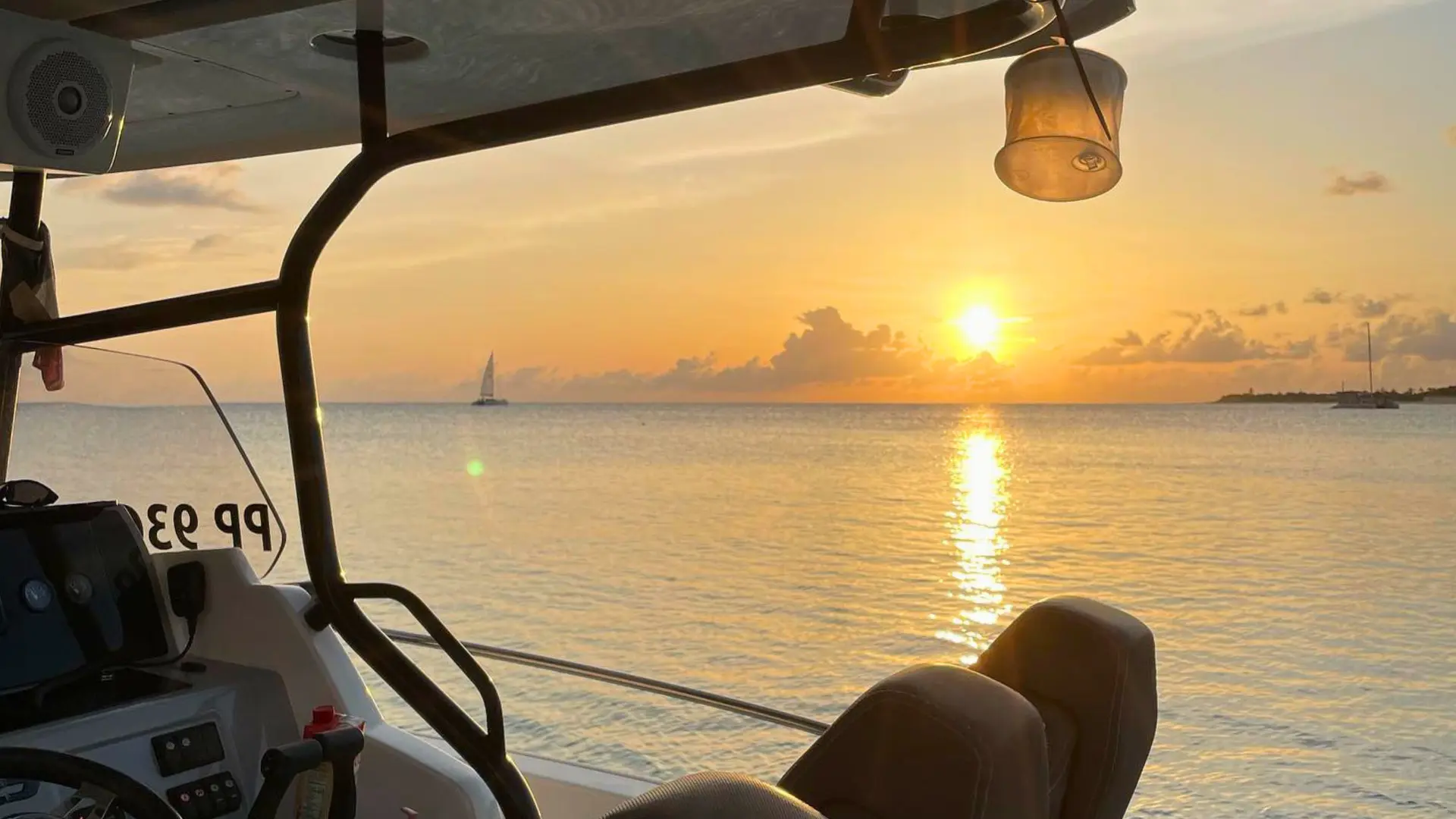 Golden sunset over calm Caribbean waters viewed from a private speedboat near St Martin