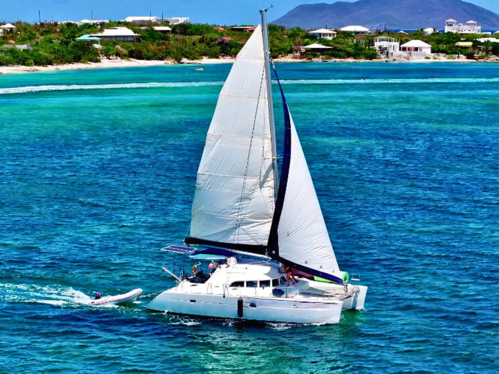 Catamaran sailing off the coast of St Martin in crystal clear Caribbean water