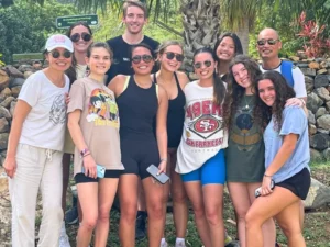 Visitors enjoying a guided cultural tour stop in St Martin with local heritage landmark