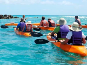 Glass bottom kayak floating above clear blue water showing the kayak hull from below in Simpson Bay, St Maarten