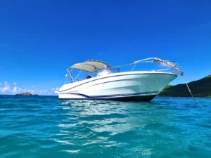 Private motorboat anchored in turquoise waters near St Martin coastline