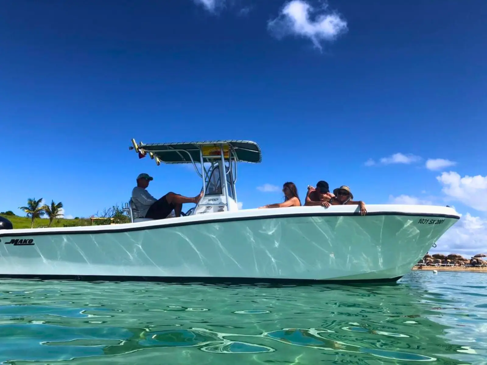 Shallow-water view of a private motorboat anchored in crystal clear turquoise sea in St Maarten