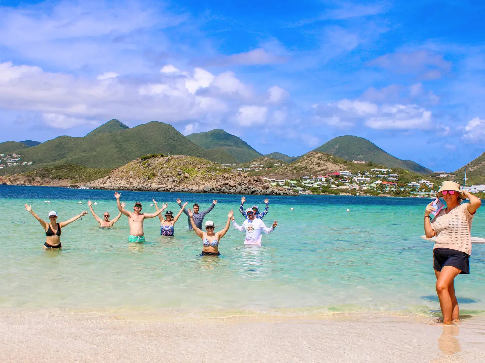 Group of guests celebrating in the water at Pinel Island, St Martin