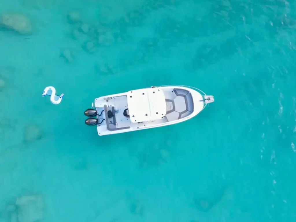 Overhead view of a private motorboat anchored in crystal-clear waters off the coast of St Martin