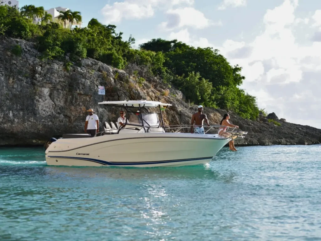 Group enjoying calm anchorage aboard a private motorboat near the St Martin coastline