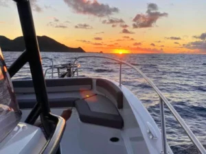 Sunset view from the bow seating area of a private boat charter in St Martin