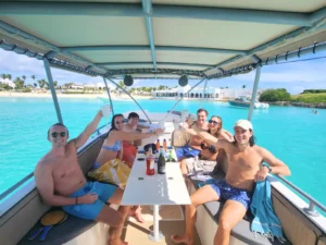 Group enjoying a private powerboat charter with drinks and shaded seating in Anguilla