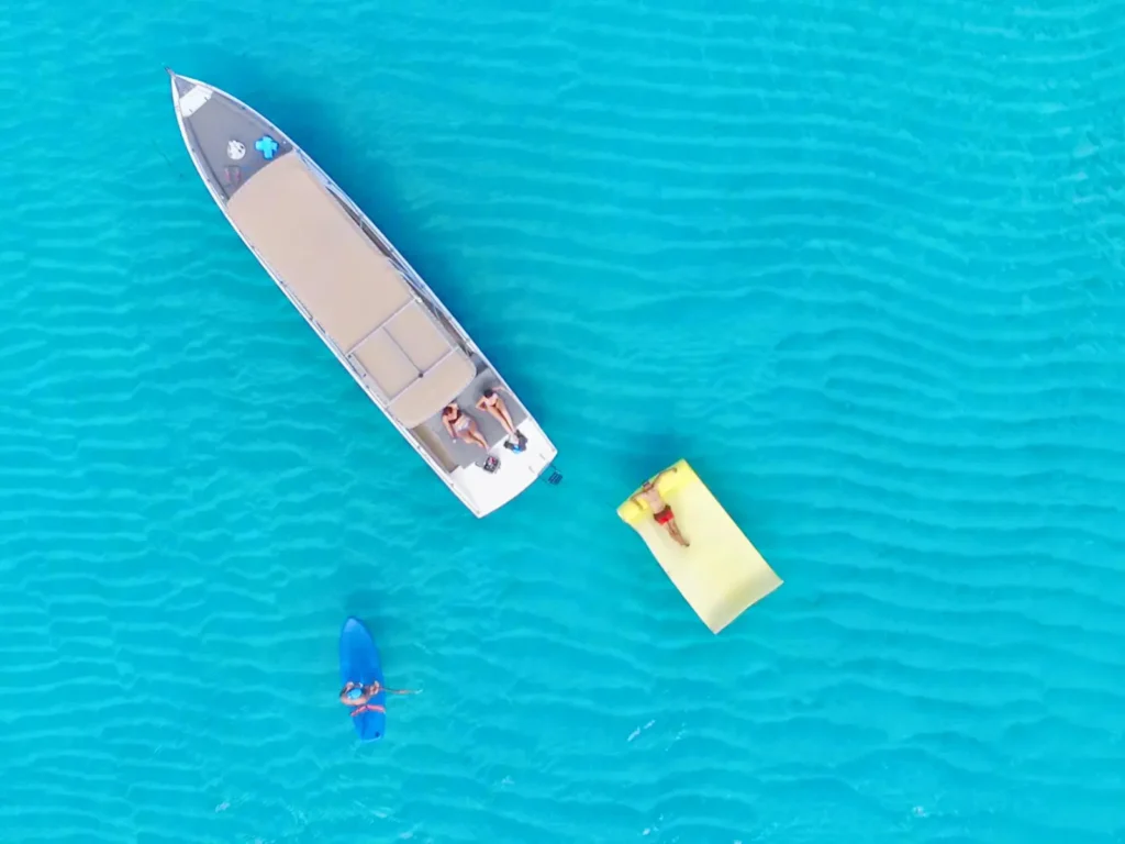 Aerial view of a private powerboat charter with sunbeds and floating mat in St Martin
