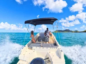 Private speedboat charter cruising off St Martin coastline with captain at helm and open sea views
