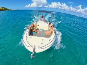 Guests relaxing on private St Martin speedboat charter cruising in clear blue Caribbean waters