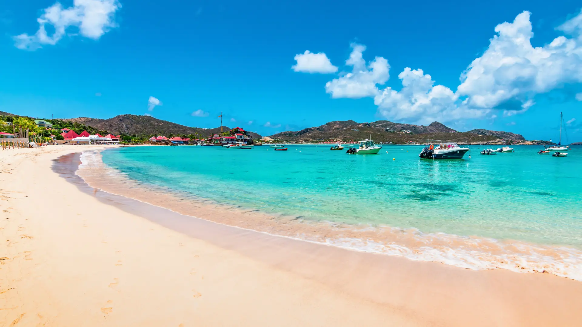 Boats anchored in St Jean St Barths with beach and turquoise bay
