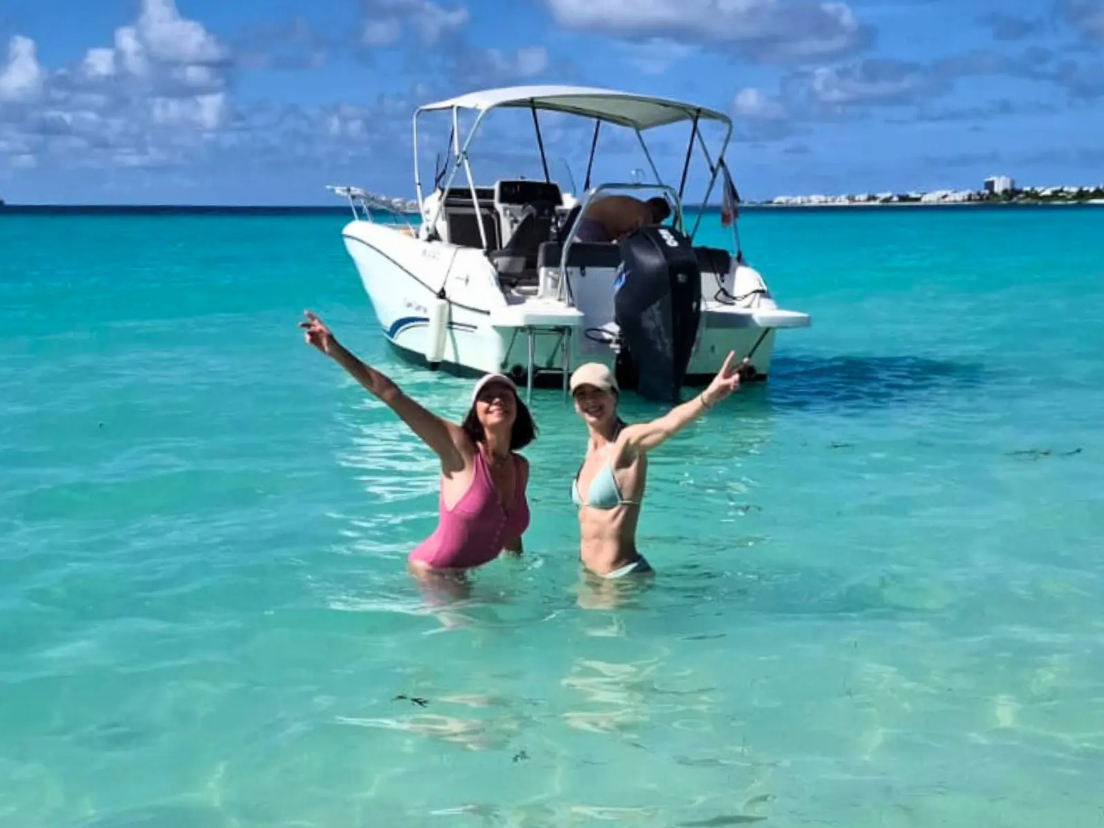 Guests enjoying a private boat charter in crystal-clear turquoise water in Saint Martin