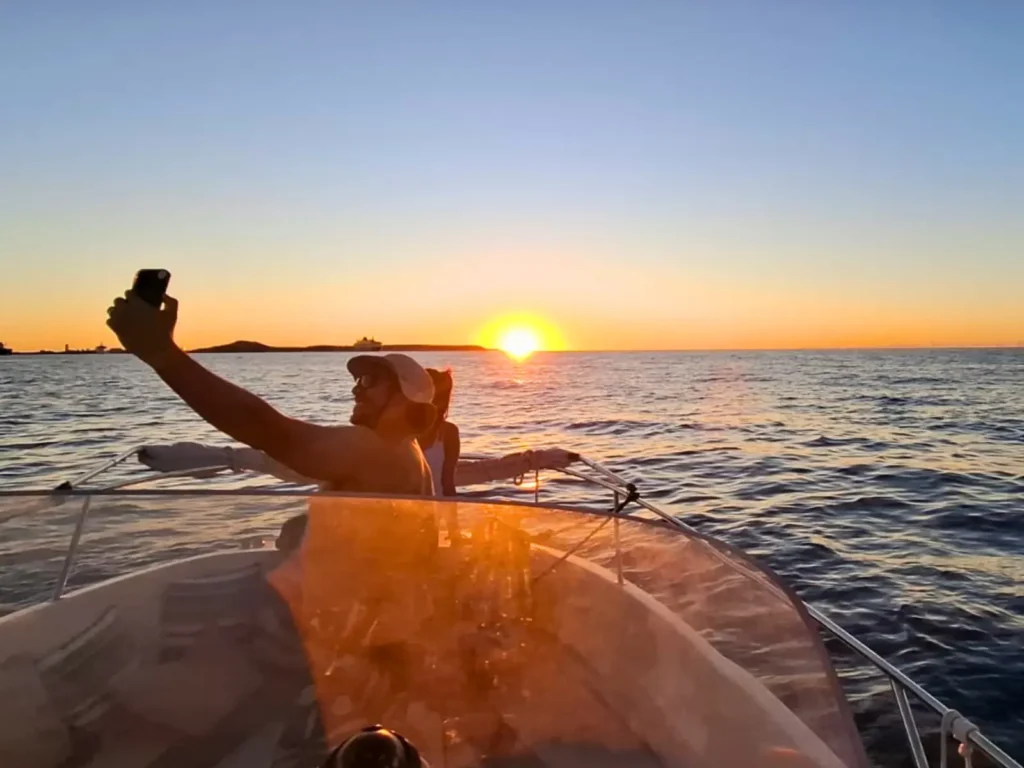 Guest taking a sunset selfie on a private boat charter in Saint Martin
