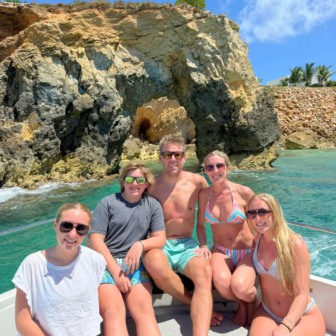 Family enjoying a private boat trip near the cliffs of St Martin