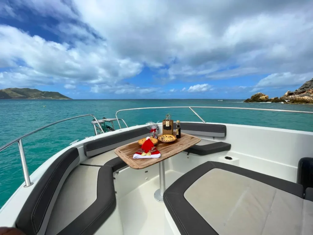 Luxury picnic setup on boat bow with ocean views St Maarten private charter experience