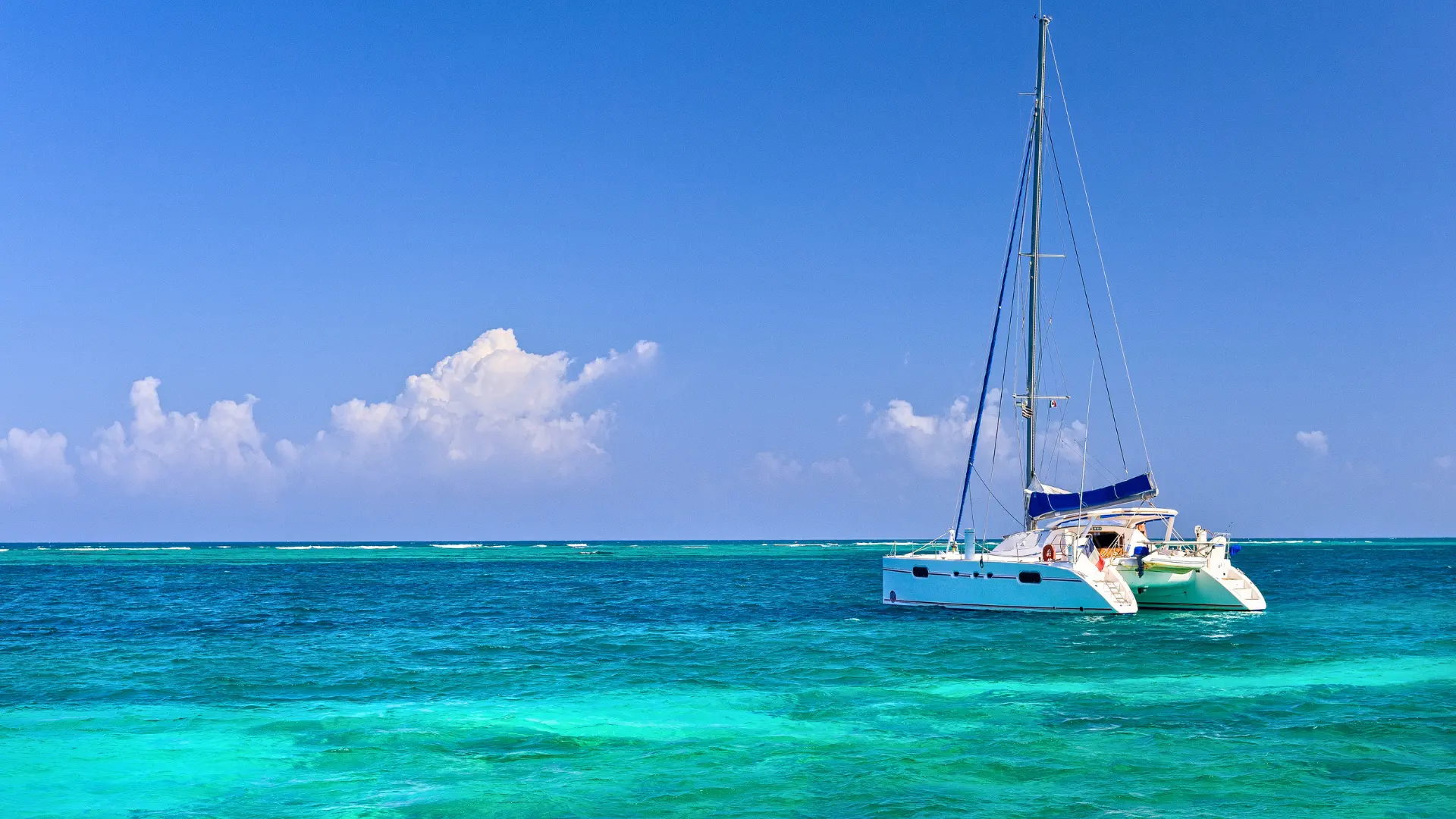 Catamaran anchored in clear turquoise water in St Martin