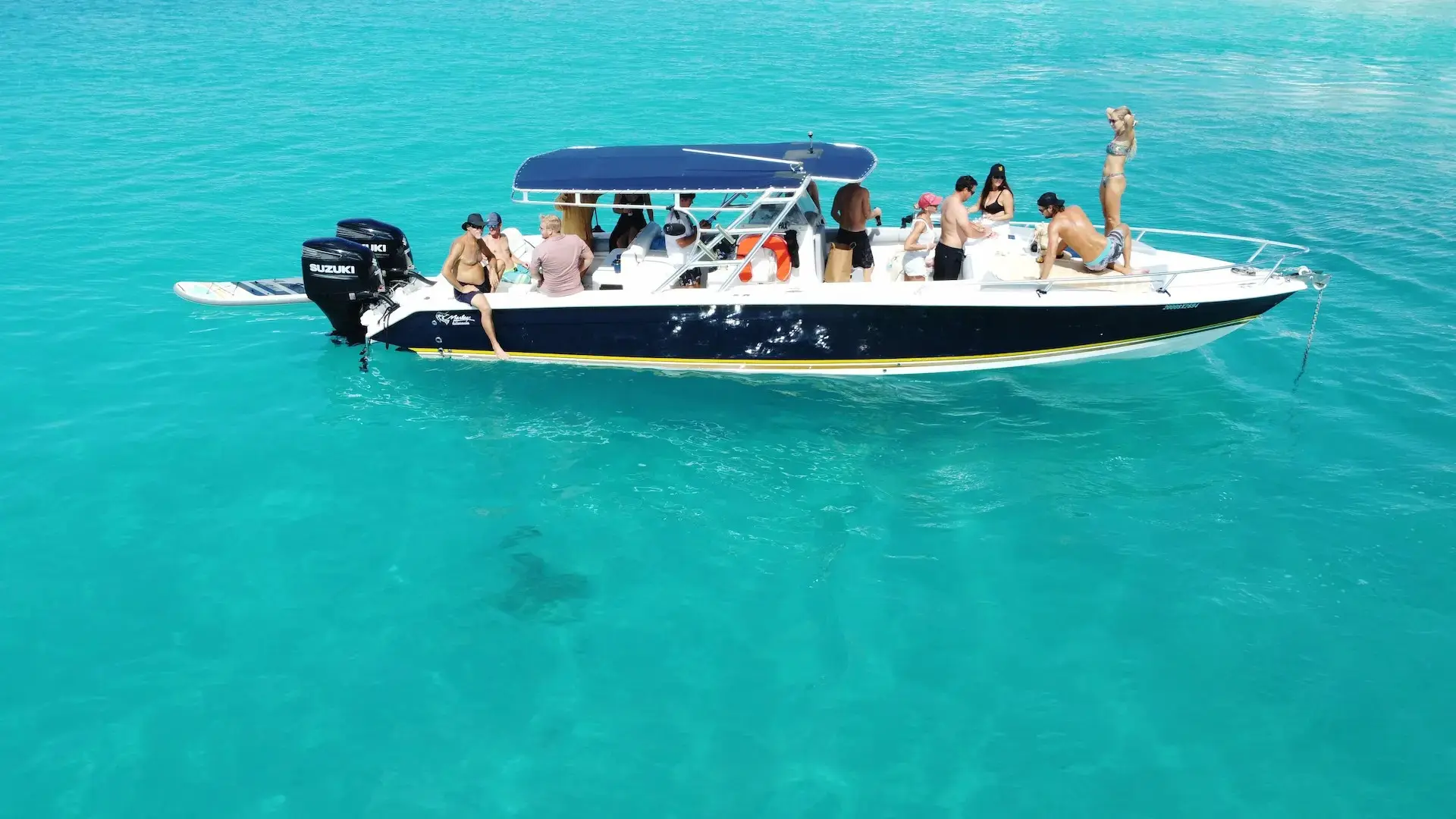 Group of people on shared boat tour in St Martin with multiple passengers onboard