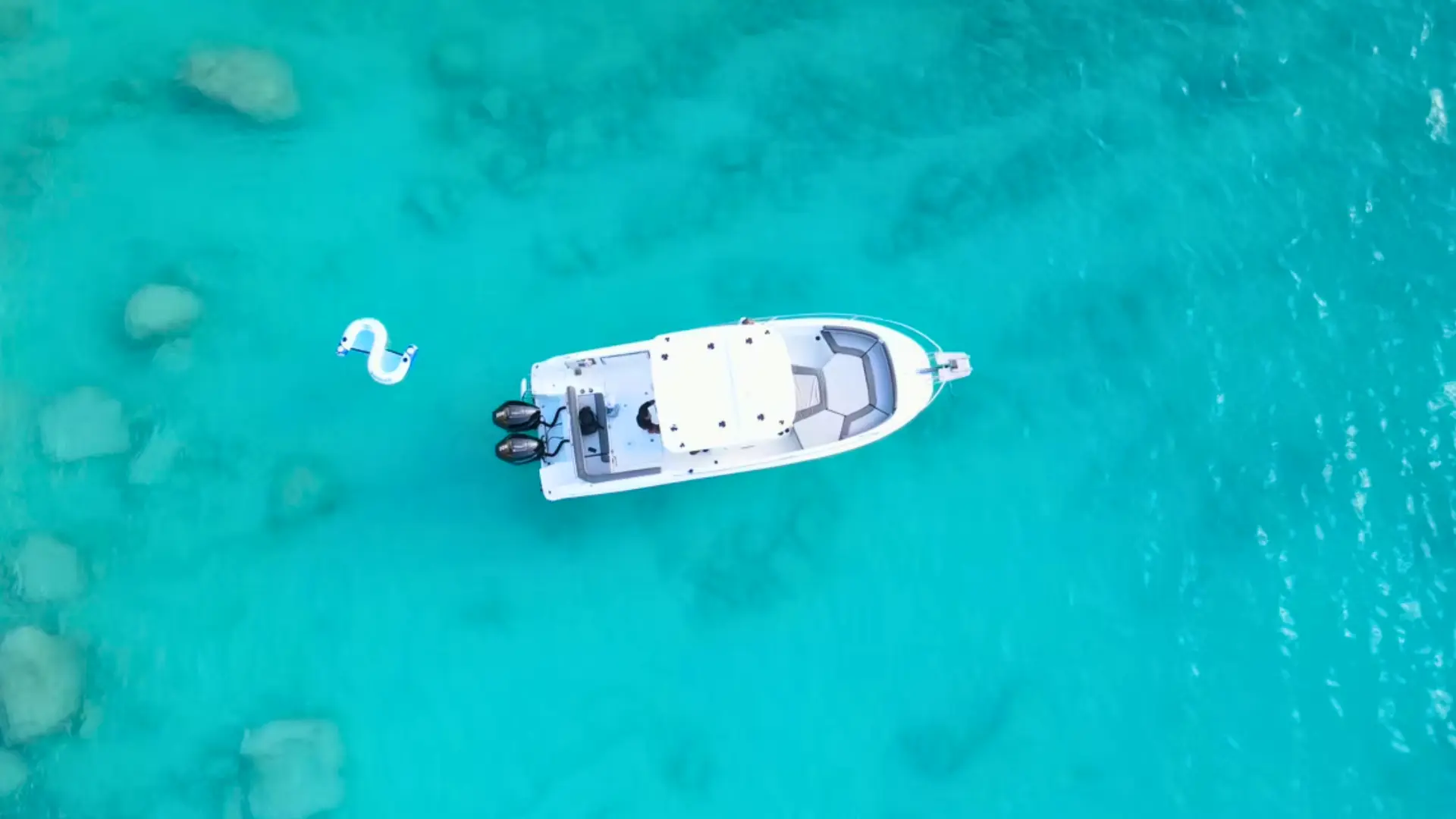 Aerial view of private boat charter in Anguilla with clear turquoise water