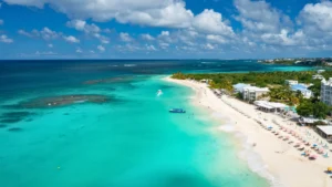 Aerial view of Anguilla beach with turquoise water and private boat offshore during a full-day charter from St Maarten
